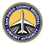 Seal of the San Diego County Regional Airport Authority featuring a central airplane over a yellow sunburst inside a blue ring with white text around the edge