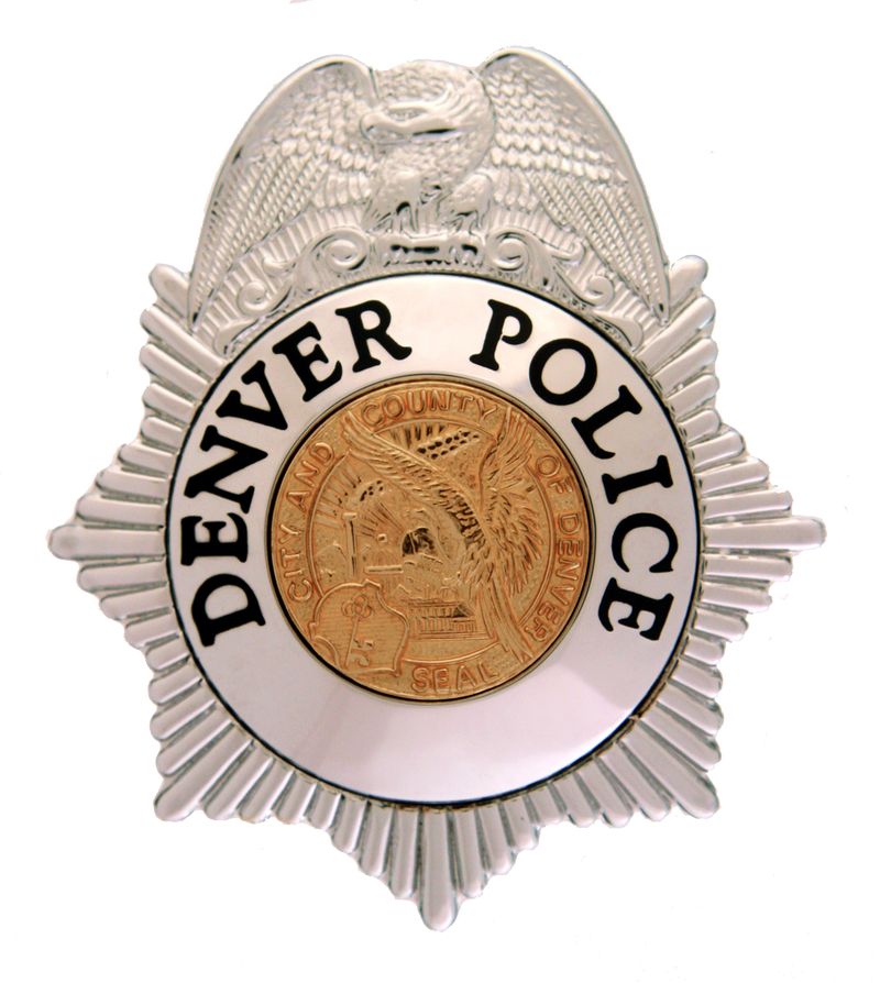 Denver Police badge featuring a silver star with an eagle crest and the gold city seal at the center
