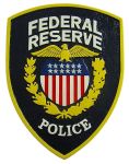 Federal Reserve Police badge on a shield shaped insignia with a laurel wreath and stars