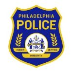 Philadelphia Police Department badge with blue shield gold border and central seal featuring scales of justice and city emblem