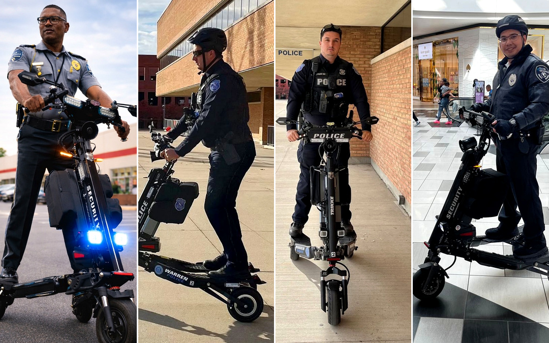 Police officer riding a black electric scooter with blue lights on, outdoor setting in a parking lot or street area.